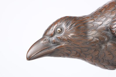 Lot 819 - A MEIJI PERIOD JAPANESE BRONZE MODEL OF A CROW ON A CARVED ROOT WOOD STAND