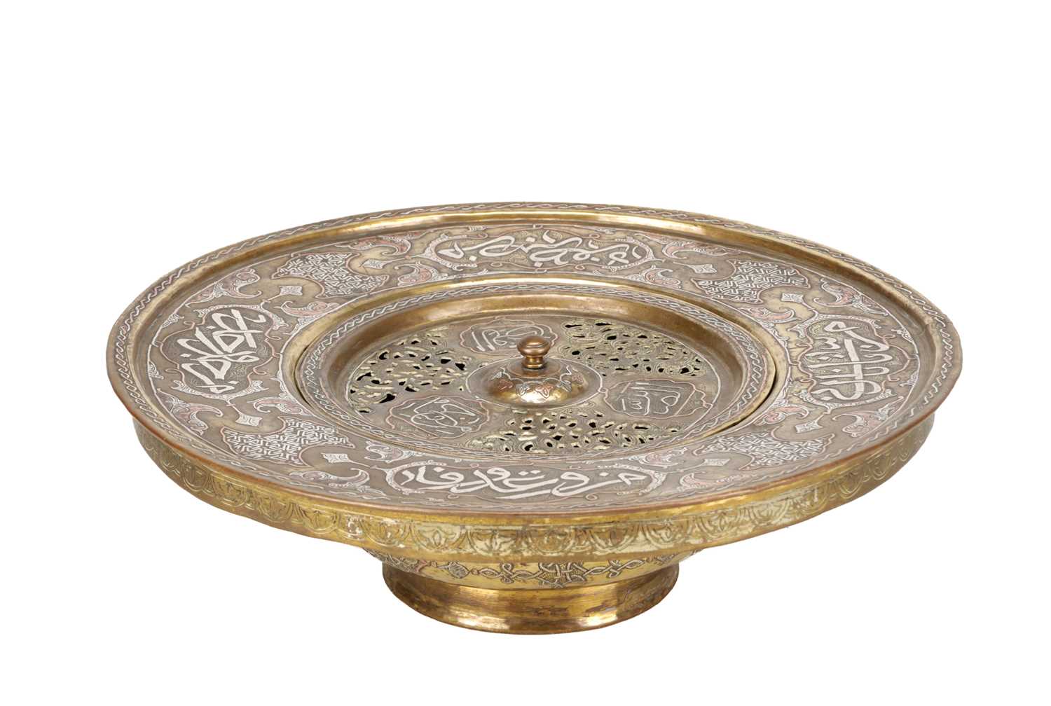 Lot 776 - A 19TH CENTURY ISLAMIC BRASS AND SILVER INLAID WASH BASIN WITH CENTRAL PIERCED STRAINER