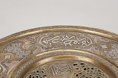 Lot 776 - A 19TH CENTURY ISLAMIC BRASS AND SILVER INLAID WASH BASIN WITH CENTRAL PIERCED STRAINER