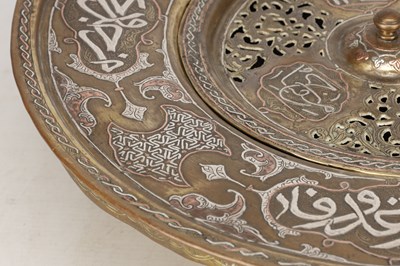 Lot 776 - A 19TH CENTURY ISLAMIC BRASS AND SILVER INLAID WASH BASIN WITH CENTRAL PIERCED STRAINER