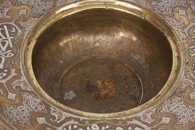 Lot 776 - A 19TH CENTURY ISLAMIC BRASS AND SILVER INLAID WASH BASIN WITH CENTRAL PIERCED STRAINER
