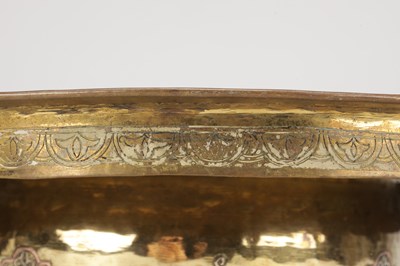Lot 776 - A 19TH CENTURY ISLAMIC BRASS AND SILVER INLAID WASH BASIN WITH CENTRAL PIERCED STRAINER