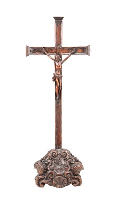 Lot 1377 - A 17TH CENTURY CARVED WALNUT CRUCIFIX ON A BAROQUE SCROLL BASE