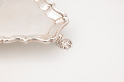 Lot 99 - A GEORGE II ENGLISH SILVER TRIANGULAR SALVER BY HUGH MILLS, LONDON