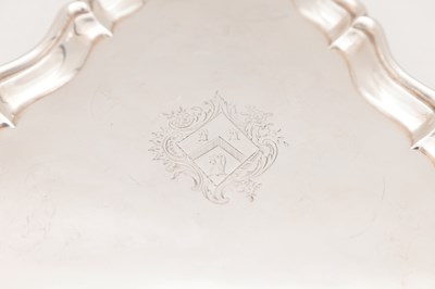 Lot 99 - A GEORGE II ENGLISH SILVER TRIANGULAR SALVER BY HUGH MILLS, LONDON