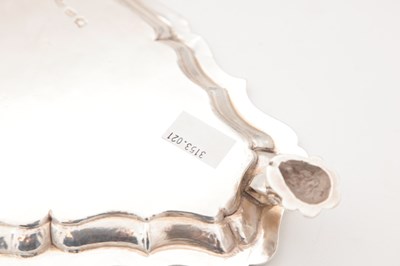 Lot 99 - A GEORGE II ENGLISH SILVER TRIANGULAR SALVER BY HUGH MILLS, LONDON