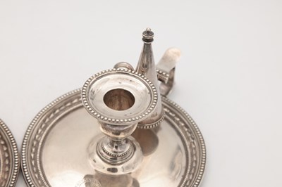 Lot 67 - A PAIR OF VICTORIAN ENGLISH SILVER CHAMBERSTICKS WITH CONICAL SNUFFERS