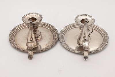 Lot 67 - A PAIR OF VICTORIAN ENGLISH SILVER CHAMBERSTICKS WITH CONICAL SNUFFERS