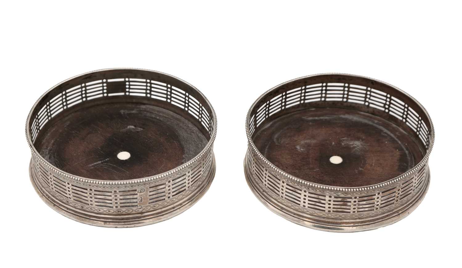 Lot 15 - A PAIR OF GEORGE III ENGLISH SILVER WINE COASTERS