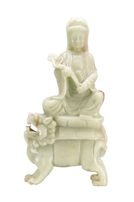 Lot 700 - A 19TH CENTURY CHINESE CELADON JADE FIGURE SEATED ON A BUDDHIST LION