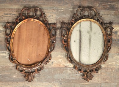 Lot 1669 - A PAIR OF 18TH CENTURY CARVED GILT WOOD OVAL HANGING MIRRORS
