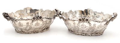 Lot 115 - A PAIR OF EDWARDIAN ENGLISH SILVER TWO-HANDLED BASKETS