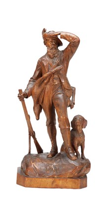 Lot 1383 - A 19TH CENTURY BLACK FOREST CARVED LINDEN WOOD SCULPTURE OF A HUNTER AND HOUND