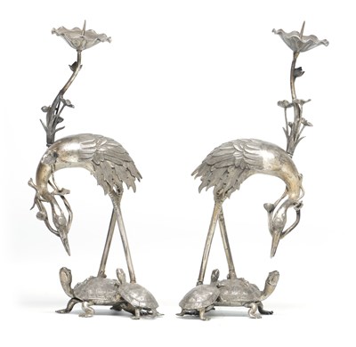 Lot 736 - A PAIR OF MEIJI PERIOD JAPANESE WHITE METAL CANDLESTICKS FORMED AS CRANES STANDING ON TORTOISES