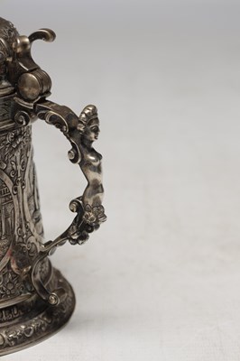 Lot 50 - A CONTINENTAL SILVER LIDDED TANKARD WITH FIGURAL FINIAL