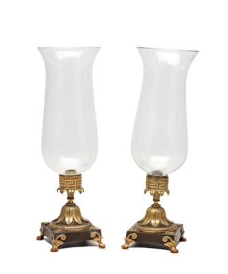 Lot A PAIR OF REGENCY BRONZE AND GILT BRONZE STORM LAMPS WITH GLASS HURRICANE SHADES