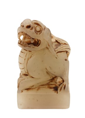 Lot AN 18TH/19TH CENTURY CHINESE WHITE JADE SEAL CARVED WITH A MYTHICAL BEAST FINIAL