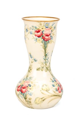 Lot A WILLIAM MOORCROFT FOR JAMES MACINTYRE AND CO. EARTHENWARE VASE DECORATED WITH ROSE, TULIP AND FORGET-ME-NOT PATTERN