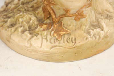Lot A PAIR OF 20TH CENTURY ROYAL WORCESTER HADLEY PORCELAIN FIGURAL CANDLESTICKS