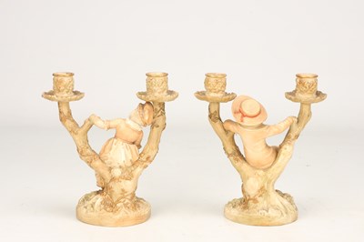 Lot A PAIR OF 20TH CENTURY ROYAL WORCESTER HADLEY PORCELAIN FIGURAL CANDLESTICKS