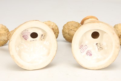 Lot A PAIR OF 20TH CENTURY ROYAL WORCESTER HADLEY PORCELAIN FIGURAL CANDLESTICKS