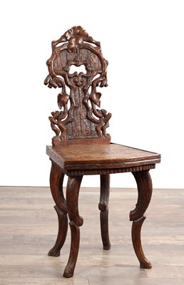 Lot A 19TH CENTURY BLACK FOREST CARVED WALNUT SIDE CHAIR