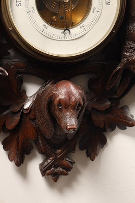 Lot 11 - A 19TH CENTURY BLACK FOREST CARVED LINDEN WOOD ANEROID HANGING BAROMETER