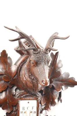 Lot 11 - A 19TH CENTURY BLACK FOREST CARVED LINDEN WOOD ANEROID HANGING BAROMETER