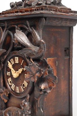 Lot 117 - A 19TH CENTURY BLACK FOREST CARVED WALNUT DOUBLE FUSEE CUCKOO CLOCK