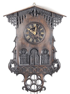Lot 60 - AN UNUSUAL 19TH CENTURY AND LATER CARVED OAK BLACK FOREST FLUTE PLAYER CUCKOO CLOCK