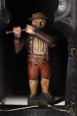 Lot 60 - AN UNUSUAL 19TH CENTURY AND LATER CARVED OAK BLACK FOREST FLUTE PLAYER CUCKOO CLOCK