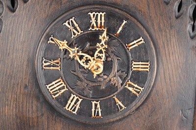 Lot 60 - AN UNUSUAL 19TH CENTURY AND LATER CARVED OAK BLACK FOREST FLUTE PLAYER CUCKOO CLOCK