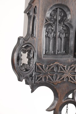 Lot 60 - AN UNUSUAL 19TH CENTURY AND LATER CARVED OAK BLACK FOREST FLUTE PLAYER CUCKOO CLOCK