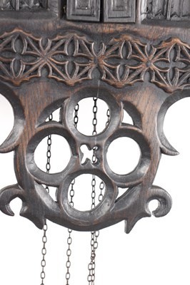 Lot 60 - AN UNUSUAL 19TH CENTURY AND LATER CARVED OAK BLACK FOREST FLUTE PLAYER CUCKOO CLOCK