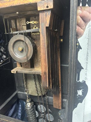 Lot 60 - AN UNUSUAL 19TH CENTURY AND LATER CARVED OAK BLACK FOREST FLUTE PLAYER CUCKOO CLOCK