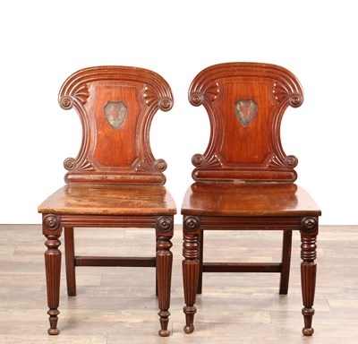 Lot A PAIR OF REGENCY MAHOGANY HALL CHAIRS IN THE MANNER OF GILLOWS