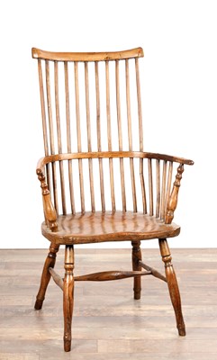 Lot AN 18TH CENTURY ASH AND ELM COMB-BACK WINDSOR ARMCHAIR
