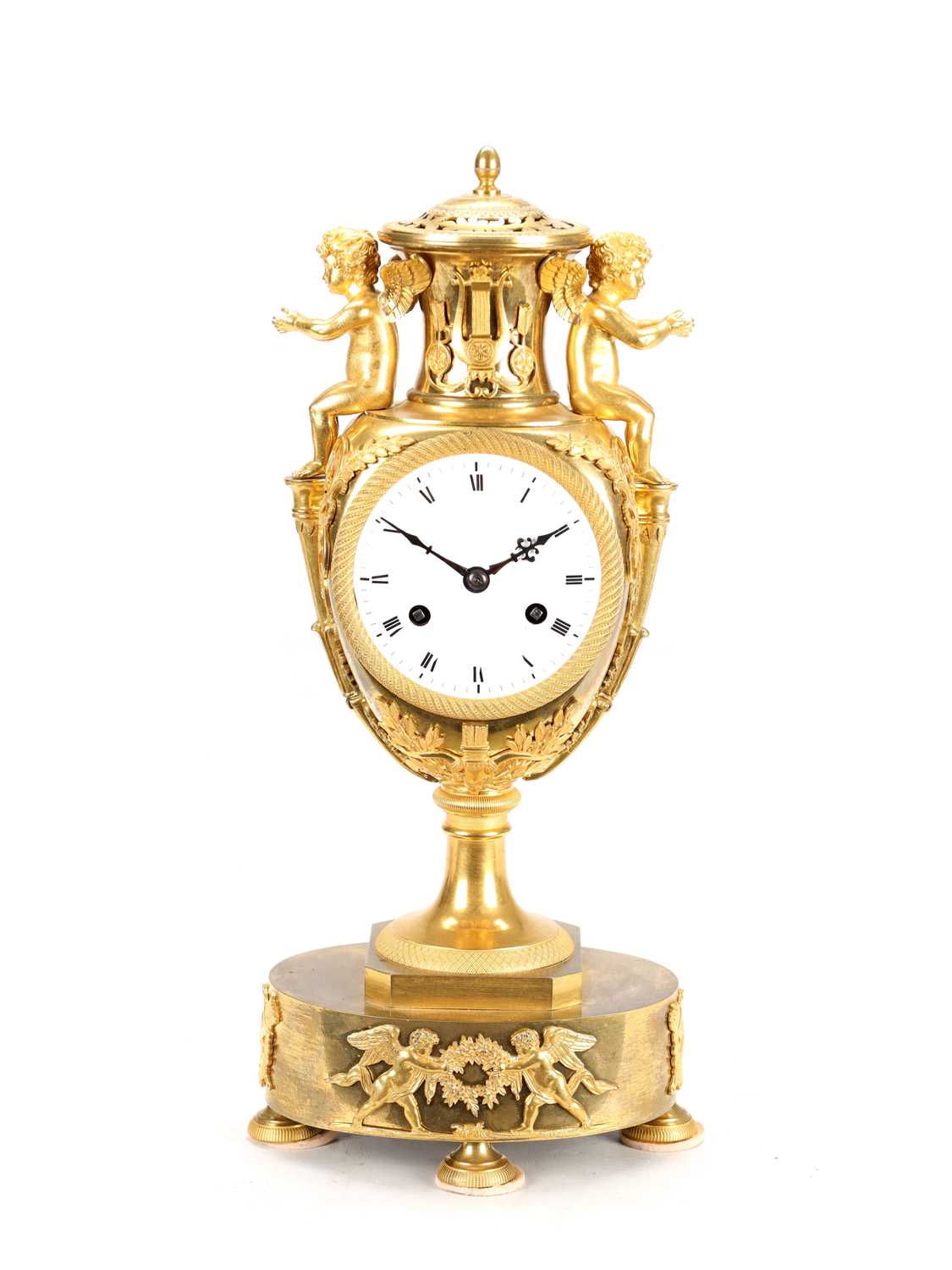 Lot 70 - AN EARLY 19TH CENTURY FRENCH ORMOLU URN-FORM MANTEL CLOCK WITH PUTTI MOUNTS