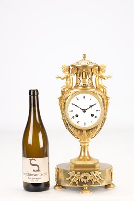 Lot 70 - AN EARLY 19TH CENTURY FRENCH ORMOLU URN-FORM MANTEL CLOCK WITH PUTTI MOUNTS