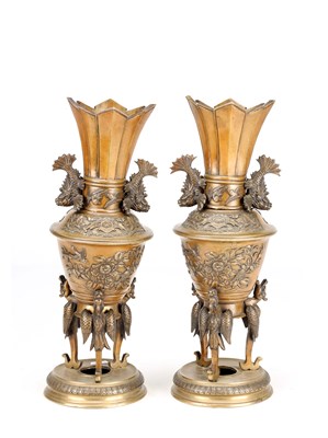 Lot A PAIR OF JAPANESE BRONZE VASES WITH DRAGON-FISH HANDLES ON BIRD SUPPORTS
