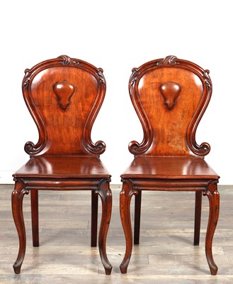 Lot A PAIR OF LATE REGENCY FIGURED MAHOGANY HALL CHAIRS