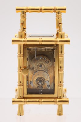 Lot 23 - A LATE 19TH CENTURY FRENCH MINIATURE GILT BRASS AND PORCELAIN PANELLED CARRIAGE CLOCK