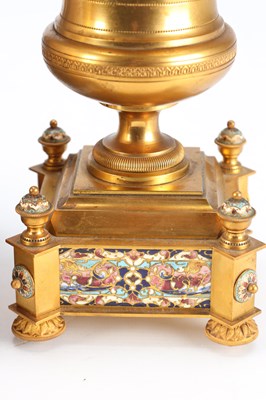 Lot 74 - A GOOD QUALITY LATE 19TH CENTURY FRENCH GILT CASED CHAMPLEVE ENAMEL AND PORCELAIN PANELLED CLOCK GARNITURE