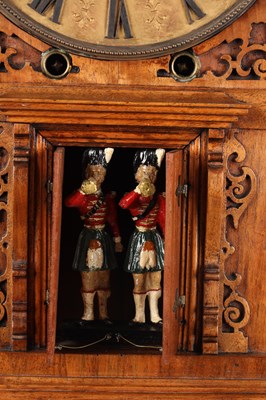 Lot 156 - A MID 19TH CENTURY BLACK FOREST WALNUT TRUMPETER CLOCK
