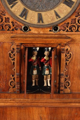 Lot 156 - A MID 19TH CENTURY BLACK FOREST WALNUT TRUMPETER CLOCK