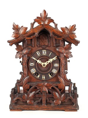 Lot 4 - A LATE 19TH CENTURY BLACK FOREST CARVED WOOD CUCKOO CLOCK