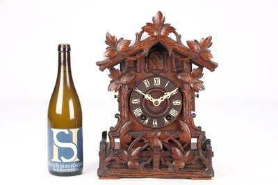 Lot 4 - A LATE 19TH CENTURY BLACK FOREST CARVED WOOD CUCKOO CLOCK
