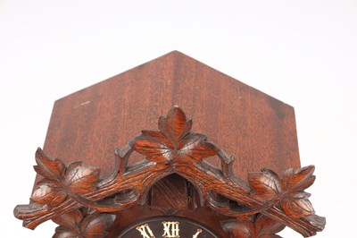 Lot 4 - A LATE 19TH CENTURY BLACK FOREST CARVED WOOD CUCKOO CLOCK