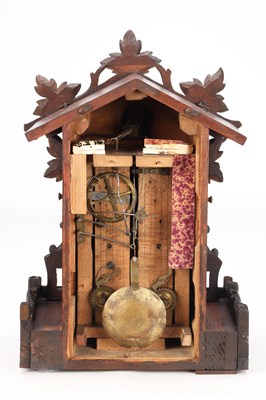 Lot 4 - A LATE 19TH CENTURY BLACK FOREST CARVED WOOD CUCKOO CLOCK