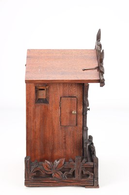 Lot 4 - A LATE 19TH CENTURY BLACK FOREST CARVED WOOD CUCKOO CLOCK